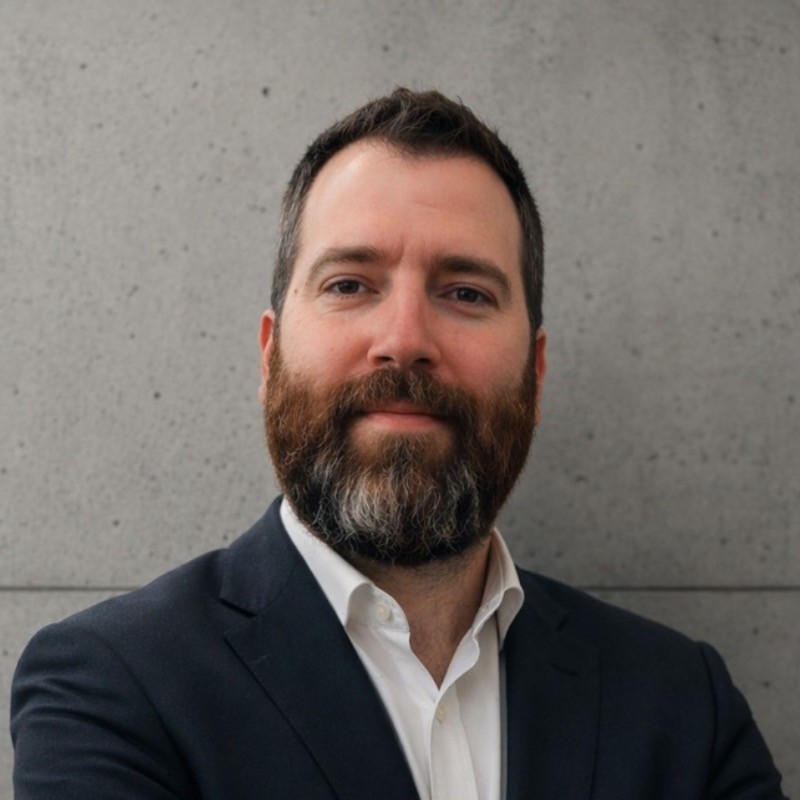 Portrait of Ohad Ben-Gad, founder of Tehomic, against a concrete wall background.